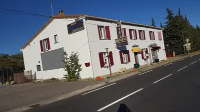 a white building on the side of a street at Hotel Ô Fil de L'ô in Marseillette