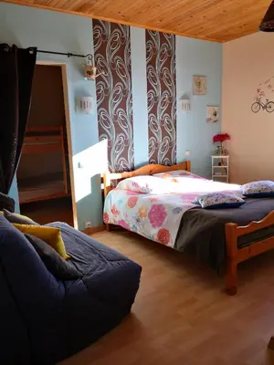 a bedroom with a bed and a couch at Hotel Ô Fil de L'ô in Marseillette