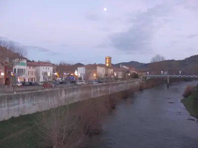 a bridge over a river next to a city at The Railway Cottage at Montazels in Espéraza