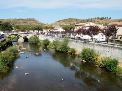 a river with a bridge in a city at The Railway Cottage at Montazels in Espéraza