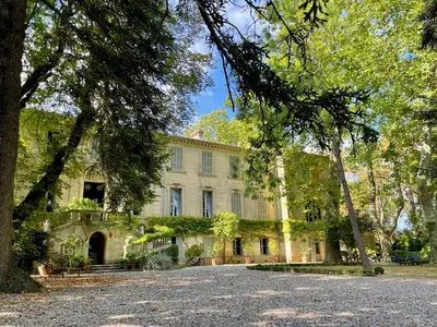 a large house with trees in front of it at La Suite de la Bastide in Val-de-Dagne