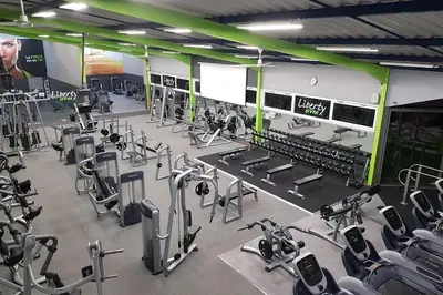 a gym with a lot of cardio equipment in it at Hôtel Renaissance in Castres
