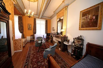 a living room with a couch and a table at Hôtel Renaissance in Castres