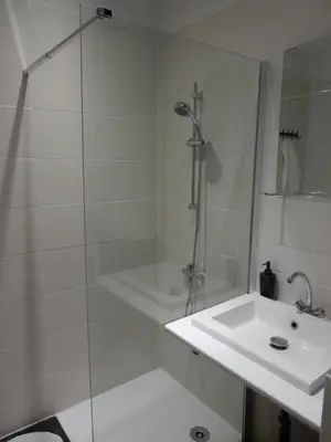 a bathroom with a shower and a sink at Cafe Vals in Vals