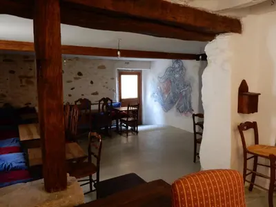 a dining room with a painting on the wall at Cafe Vals in Vals