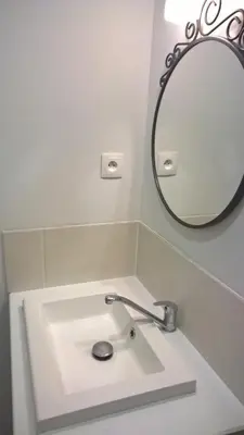 a bathroom with a sink and a mirror at Cafe Vals in Vals