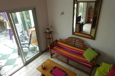 a room with a bench and a table and a mirror at Gîte du Fenouil in Lézignan-Corbières
