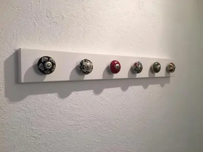 a shelf with four buttons on a wall at Hotel Axat in Axat