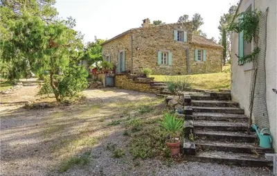 an old stone house with stairs in front of it at Amazing Home In Ribaute in Ribaute