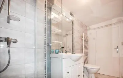 a bathroom with a toilet and a sink and a shower at Cozy Apartment In Vinassan With Wifi in Vinassan