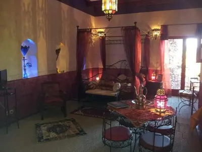 a living room with a table and chairs and a couch at La Lucques Masabelle in Mirepeisset