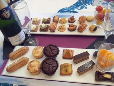 a plate of cookies and pastries and glasses of wine at La Lucques Masabelle in Mirepeisset