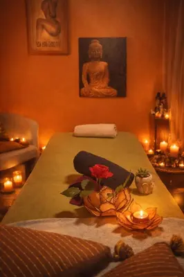 a room with a table with candles and a buddha statue at La Lucques Masabelle in Mirepeisset
