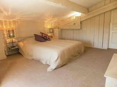 a bedroom with a large bed with two lights at Holiday Home in Loupia with Private Pool in Loupia
