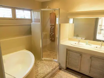 a bathroom with a shower and two sinks and a toilet at Holiday Home in Loupia with Private Pool in Loupia