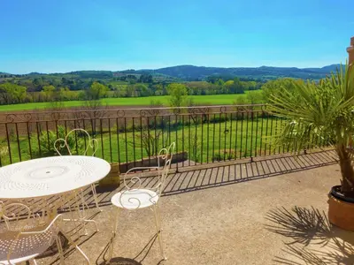 a table and chairs on a balcony with a view at Holiday Home in Loupia with Private Pool in Loupia
