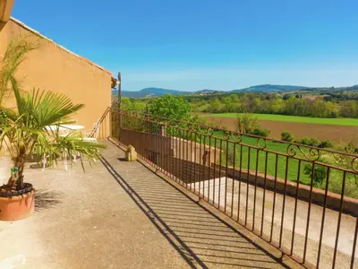 a balcony with a fence and a view of a field at Holiday Home in Loupia with Private Pool in Loupia
