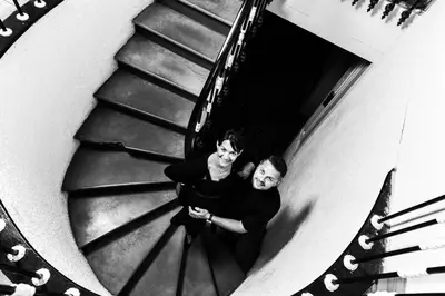 two men are standing on a spiral staircase at Logis Hôtel Restaurant des Corbières in Lagrasse