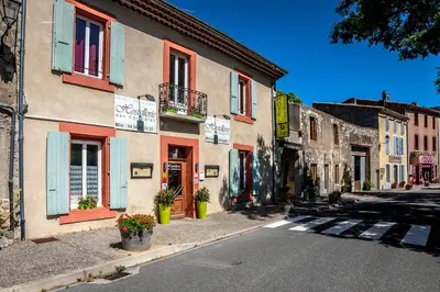 an empty street in a town with a building at Logis Hôtel Restaurant des Corbières in Lagrasse
