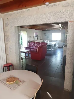 a living room with a table and a couch at gite a la campagne in Noailhac