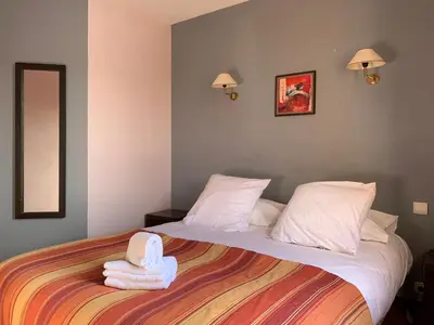 a bedroom with a bed with two towels on it at Le Mas De Gaujac in Lézignan-Corbières