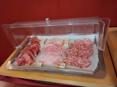 a plastic container filled with different types of meat at Le Mas De Gaujac in Lézignan-Corbières