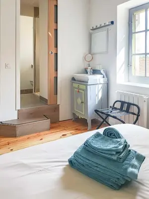 a bedroom with a bed and a sink and a mirror at La Bonne Planque - Maison éclusière de La Planque in Mas-Saintes-Puelles