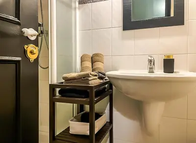 a bathroom with a sink and a toilet and a mirror at RétroMirabeau - CHAMBRE Suite & APPARTEMENTS de Charme - Localisation Prémium in Narbonne