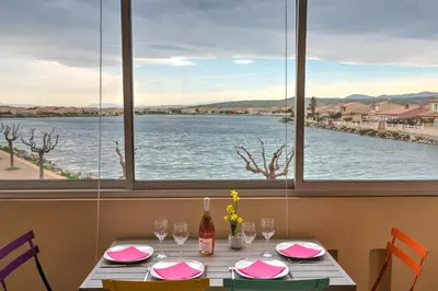 a table with a view of the water at Appartement Le Flamant Rose in Port-la-Nouvelle