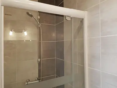 a shower with a glass door in a bathroom at Peaceful Poolside Escape in Montouliers