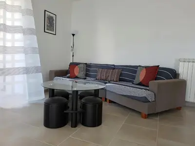a living room with a couch and a table at Peaceful Poolside Escape in Montouliers