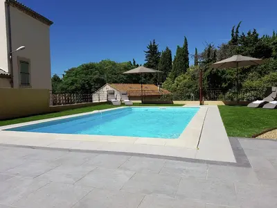a swimming pool in the backyard of a house at Peaceful Poolside Escape in Montouliers