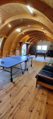 a ping pong table in the middle of a room at Fount de Cousteno in Limbrassac