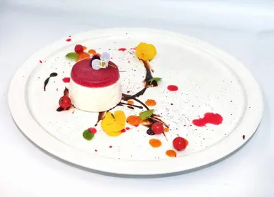 a dessert on a white plate on a table at LOGIS Hôtel Restaurant Le Clos Fleuri in Castelnaudary