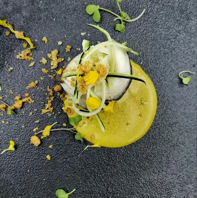 a deviled egg on top of a lemon on a table at LOGIS Hôtel Restaurant Le Clos Fleuri in Castelnaudary
