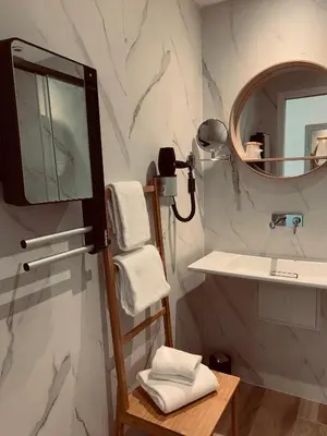 a bathroom with a sink and a mirror at LOGIS Hôtel Restaurant Le Clos Fleuri in Castelnaudary