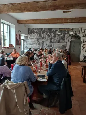 a group of people sitting at a table in a restaurant at Contact Hôtel Le Minervois - Hôtel & Restaurant Au nord de Carcassonne in Caunes-Minervois