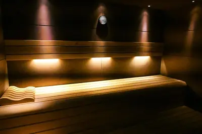 a bench in a room with lights on it at Domaine Riberach - Restaurant étoilé - Spa - Piscine naturelle - Vignoble bio in Bélesta
