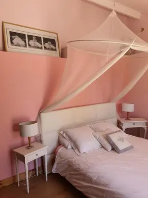 a bedroom with a bed and two tables with lamps at B&B Le Patio En Ville - Chambres d'hôtes in Narbonne