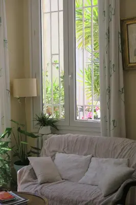 a living room with a couch and a window at B&B Le Patio En Ville - Chambres d'hôtes in Narbonne