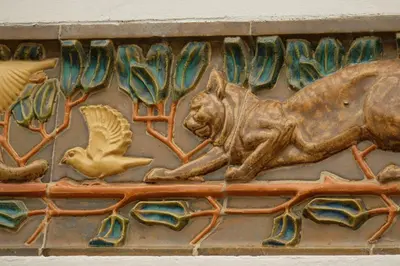a relief of a lion and a bird on a wall at B&B Le Patio En Ville - Chambres d'hôtes in Narbonne