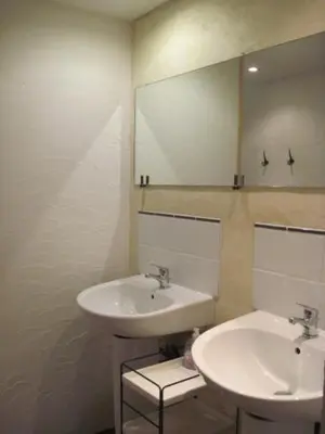a bathroom with two sinks and a mirror at Le Ribet in Lempaut