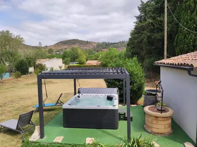 a hot tub in a gazebo in a yard at Gite CATHARE en OCCITANIE in Espéraza
