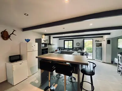 a kitchen with a large island in the middle of a room at Gite CATHARE en OCCITANIE in Espéraza