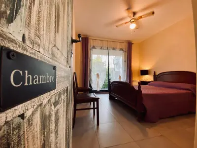 a hotel room with a bed and a sign on the wall at Gite CATHARE en OCCITANIE in Espéraza