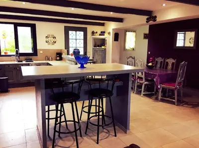 a kitchen with a large island with bar stools at Gite CATHARE en OCCITANIE in Espéraza