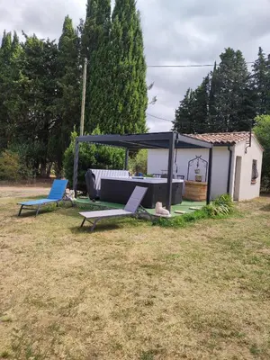 a couple of chairs and a pavilion in a yard at Gite CATHARE en OCCITANIE in Espéraza
