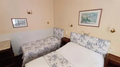 a small room with two beds in it at Hotel Montsegur in Carcassonne