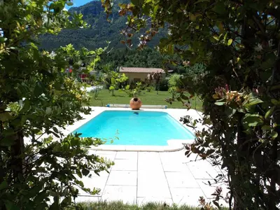 a swimming pool in the middle of a yard at Hotel Restaurant Rose des Pyrénées in Belvianes-et-Cavirac