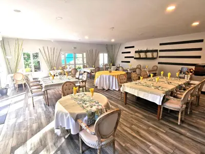 a dining room with tables and chairs and a room with at Hotel Restaurant Rose des Pyrénées in Belvianes-et-Cavirac